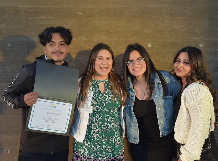 Veronica Hand with three Puente students.