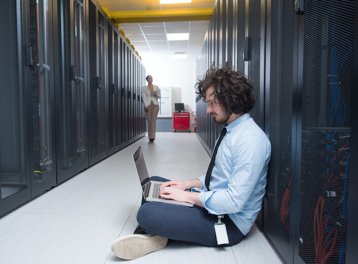 Linux Networking Team of server technicians work in data center.
