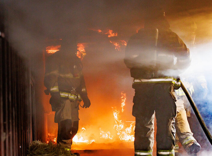 Fire Academy Fire students in gear during a drill.