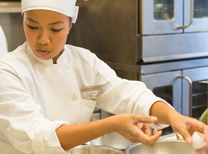 Asian girl toddler Instructor chef works with two female students in the kitchen