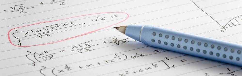 A mechanical pencil on a piece of notebook paper. An equation is circled in red.