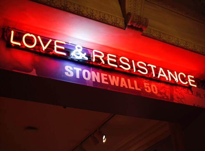 Stonewall Stonewall - a neon sign that reads "Love and Resistance" is displayed.