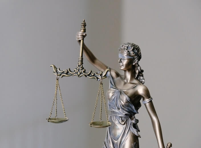 Scales of justice. Political theories - lady liberty statue in bronze holds scales of justice.