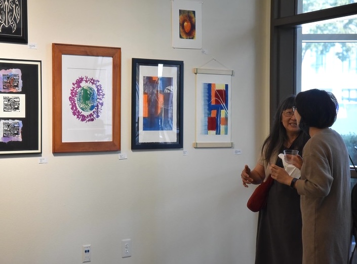 Impressions Two women look at impressionist paintings in the Vargas Gallery of Mission College.