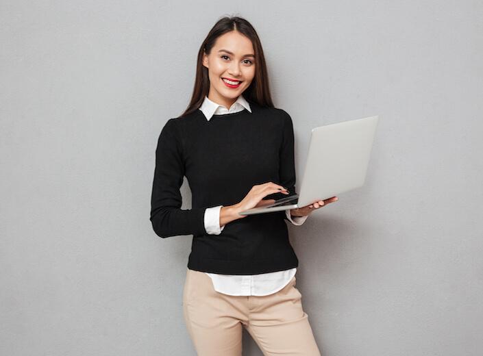 Latinx female student in blue shirt reviews some information in a brochure.