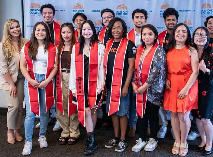 MESA group. MESA graduates in red/orange sashes.