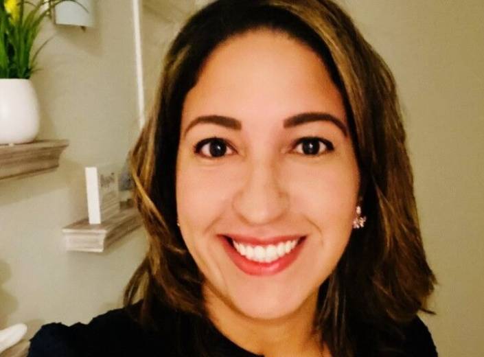 Rosa Sosa, a smiling Latina with dark hair and red lipstick.